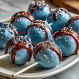 Hand-dipped cake pops in school colors, finished with shimmering gold sprinkles for a celebratory graduation dessert.
