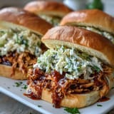 Smoky shredded chicken simmered in tangy barbecue sauce, ready for summer sandwiches.  