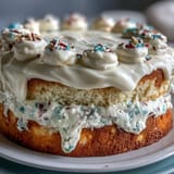 Glistening Funfetti Dip Cake topped with cheerful rainbow sprinkles, ready for parties.