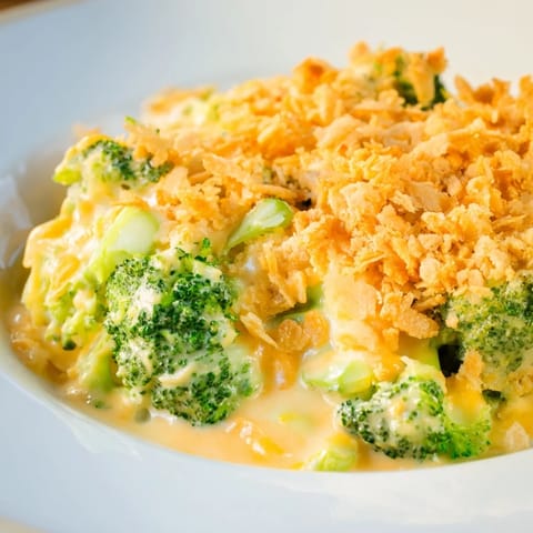 Golden-brown Broccoli Casserole with a buttery cracker topping, bubbling in a baking dish.
