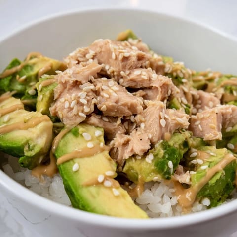 Fragrant jasmine rice forms the base of this Tuna Avocado Rice Bowl, topped with creamy avocado, crisp cucumber, and tender tuna chunks.  