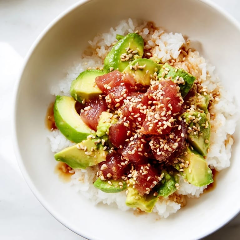 This easy Tuna Avocado Rice Bowl showcases flaked tuna, diced avocado, and scallions, served warm for a quick, nourishing fusion meal.